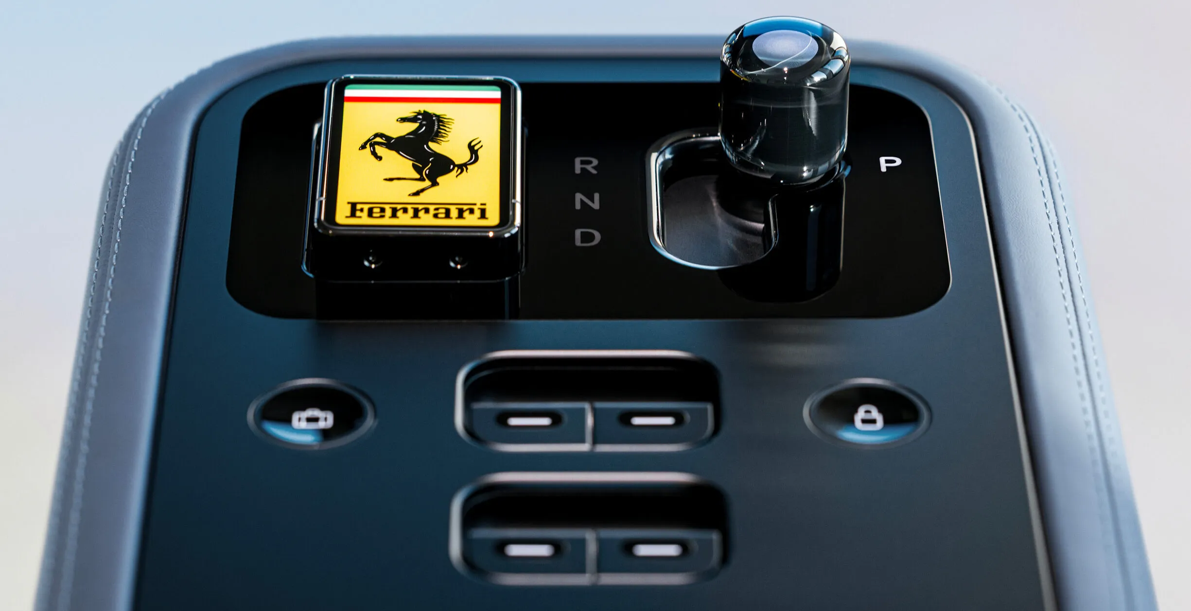 Ferrari Luce center console showing the gear selector next to a row of physical toggle buttons