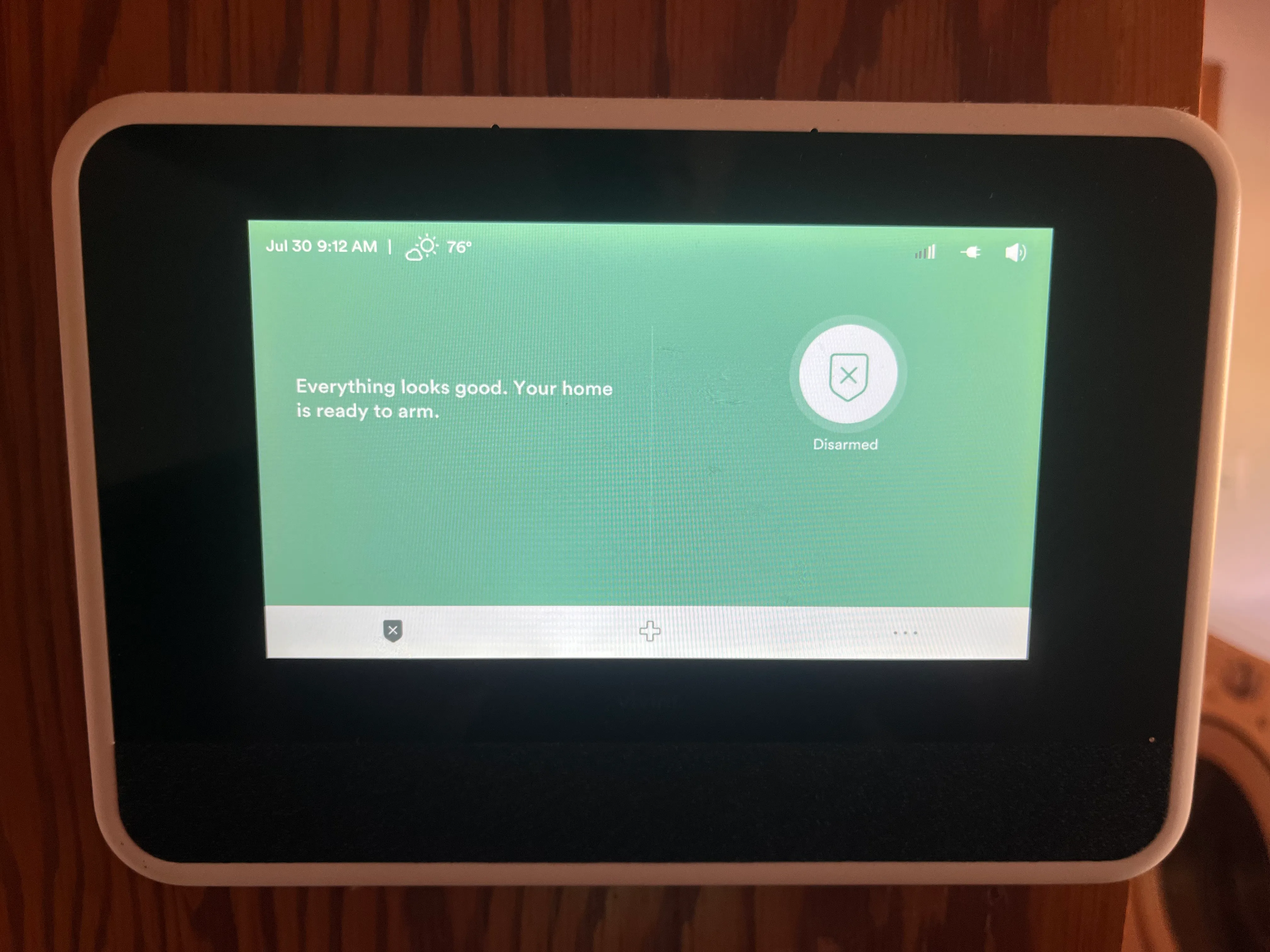 A home security touchscreen panel reading "Everything looks good. Your home is ready to arm."